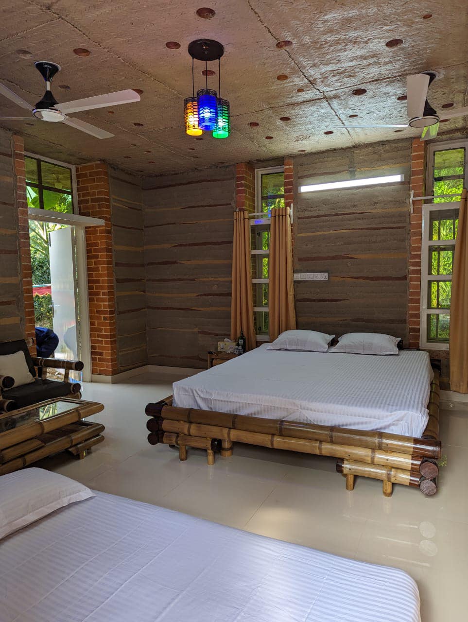 Earth-toned minimal luxury bed layout in The Mud Den